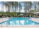 Beautiful community pool offers a refreshing escape with plenty of lounge chairs and surrounding greenery at 210 Quimby Hill Dr, Huger, SC 29450
