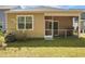 Cozy screened porch and back yard with green lawn and mature landscaping at 212 Sweet Cherry Ln, Summerville, SC 29486