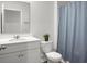 Standard white bathroom features a vanity, toilet, mirror, and shower with a curtain at 212 Sweet Cherry Ln, Summerville, SC 29486