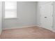 Simple bedroom with plush carpet, a window with blinds, and a closet with double doors at 212 Sweet Cherry Ln, Summerville, SC 29486