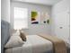 Cozy bedroom featuring a bed with decorative pillows and two framed pictures on the wall at 212 Sweet Cherry Ln, Summerville, SC 29486
