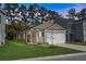 Charming single-story home with a well-manicured lawn, attached garage, and inviting curb appeal at 212 Sweet Cherry Ln, Summerville, SC 29486