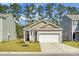Attractive single-story home with a well-maintained lawn, an attached garage, and traditional siding at 212 Sweet Cherry Ln, Summerville, SC 29486