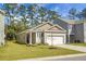 Inviting single-story home with a well-kept lawn, attached garage, and traditional architectural style at 212 Sweet Cherry Ln, Summerville, SC 29486