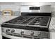 Close up of a stainless steel gas range with granite countertops and subway tile backsplash at 212 Sweet Cherry Ln, Summerville, SC 29486