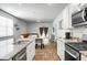 Open-concept kitchen flowing into living area with stainless appliances and granite countertops at 212 Sweet Cherry Ln, Summerville, SC 29486