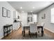 Bright open-concept kitchen flows into the dining area with stainless steel appliances and granite countertops at 212 Sweet Cherry Ln, Summerville, SC 29486
