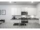 Modern kitchen featuring granite countertops, stainless steel appliances, and bright white cabinetry at 212 Sweet Cherry Ln, Summerville, SC 29486