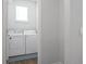 Functional laundry room with a window, updated washer and dryer, and a patterned floor mat at 212 Sweet Cherry Ln, Summerville, SC 29486