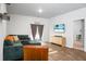 Bright living area with modern cabinet, comfortable sofa, and a beach-themed television display at 212 Sweet Cherry Ln, Summerville, SC 29486