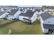 Aerial perspective revealing a generous backyard with a screened porch and a vibrant green lawn at 217 Woodland Oak Way, Summerville, SC 29485