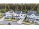 An aerial shot of white two-story homes with inviting front porches and landscaping at 217 Woodland Oak Way, Summerville, SC 29485