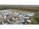 An aerial of homes in a planned community with a tranquil pond at 217 Woodland Oak Way, Summerville, SC 29485