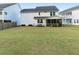 Wide view of the home and spacious backyard including the screened-in porch and patio area at 217 Woodland Oak Way, Summerville, SC 29485