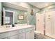 Bathroom features a white double sink vanity and walk-in shower with glass door at 217 Woodland Oak Way, Summerville, SC 29485