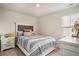 Well-lit bedroom with a patterned coverlet, and soft, natural lighting at 217 Woodland Oak Way, Summerville, SC 29485