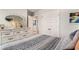 Bright bedroom features a patterned comforter, white dresser, and a decorative mirror at 217 Woodland Oak Way, Summerville, SC 29485