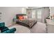 Bright bedroom featuring a tufted headboard, a patterned coverlet, and soft, natural lighting at 217 Woodland Oak Way, Summerville, SC 29485