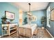 Stylish dining room with blue walls, light fixture, white table cloth, and decorative accents at 217 Woodland Oak Way, Summerville, SC 29485