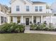 Charming front porch with rocking chair, lush plants, and welcoming curb appeal at 217 Woodland Oak Way, Summerville, SC 29485
