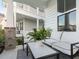 Inviting front porch with comfortable seating and a stylish black and white rug at 217 Woodland Oak Way, Summerville, SC 29485