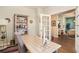 Bright home office with white desk, shelving, modern decor, and open doorway to another living space at 217 Woodland Oak Way, Summerville, SC 29485