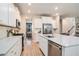 Bright kitchen with stainless appliances, white cabinets, island and granite countertops at 217 Woodland Oak Way, Summerville, SC 29485