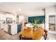 Open floor plan featuring kitchen island, dining area, and stylish living room with accent wall at 217 Woodland Oak Way, Summerville, SC 29485