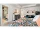 Tastefully decorated primary bedroom featuring floral bedding, a sitting area, and an ensuite bathroom at 217 Woodland Oak Way, Summerville, SC 29485