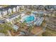 Aerial view of a community pool surrounded by palm trees and lounge areas at 217 Woodland Oak Way, Summerville, SC 29485