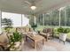 Inviting screened-in porch featuring comfortable seating and a ceiling fan, perfect for relaxing outdoors at 217 Woodland Oak Way, Summerville, SC 29485