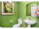 Charming powder room with green walls, stylish mirror, and a unique pelican art piece at 217 Woodland Oak Way, Summerville, SC 29485