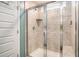 Well lit shower showcasing a tiled shower, glass door, and built-in seat at 217 Woodland Oak Way, Summerville, SC 29485