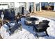 A stone firepit with Adirondack seating on a crushed gravel bed and palm trees at 2205 Cooper Farm Rd, Johns Island, SC 29455