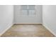 An empty bedroom with wood-look flooring and a bright window, ready for personalization at 2254 Macallan Blvd, Ravenel, SC 29470