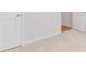 Carpeted bedroom featuring a glimpse of wood floors through an open white door at 2254 Macallan Blvd, Ravenel, SC 29470