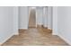 A hallway featuring wood-look flooring and a staircase, creating a welcoming entrance to the home at 2254 Macallan Blvd, Ravenel, SC 29470