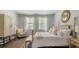 Comfortable bedroom with ample natural light, neutral tones, and a cozy chair at 2278 Macallan Blvd, Ravenel, SC 29470