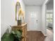 Welcoming foyer with hardwood floors, wooden cabinet, mirror, and stylish decorative accents at 2278 Macallan Blvd, Ravenel, SC 29470