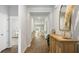 Hallway view featuring modern decor, hardwood floors, and a view into the living area at 2278 Macallan Blvd, Ravenel, SC 29470