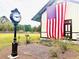 Historic Ravenel Train Depot adorned with a patriotic display, clock and greenery creating a serene and picturesque space at 2278 Macallan Blvd, Ravenel, SC 29470