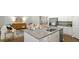 Stylish kitchen island featuring white cabinets, granite countertops, and stainless steel appliances at 2278 Macallan Blvd, Ravenel, SC 29470