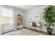 Bright, open office area featuring a large window, stylish rug, and a decorative bookshelf at 2278 Macallan Blvd, Ravenel, SC 29470