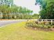 Well-manicured Hillcrest community entrance with landscaping and fencing near the street at 2278 Macallan Blvd, Ravenel, SC 29470