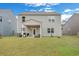 Expansive backyard features green grass, covered patio, modern gray exterior, and well-kept landscaping at 231 Hayworth Rd, Summerville, SC 29486