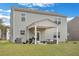 Large backyard with green grass, a covered patio, and an exterior of light gray vinyl siding at 231 Hayworth Rd, Summerville, SC 29486