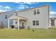 Well-maintained backyard featuring green grass, a covered patio, and a modern gray exterior at 231 Hayworth Rd, Summerville, SC 29486