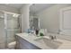 A modern bathroom with double sinks and a glass-enclosed shower offers contemporary style and functionality at 231 Hayworth Rd, Summerville, SC 29486