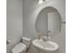 Clean and simple half-bathroom featuring a pedestal sink, oval mirror, and neutral paint, offering a functional space at 231 Hayworth Rd, Summerville, SC 29486