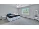 A minimalist bedroom with a large window allows natural light to fill the space at 231 Hayworth Rd, Summerville, SC 29486